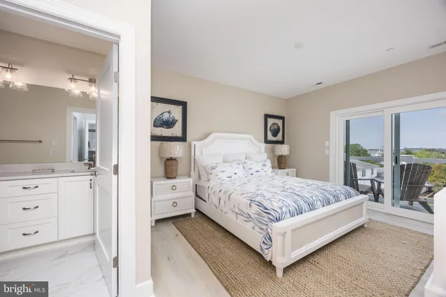 a bedroom with a large bed and a dresser