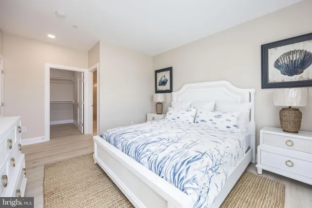 a large bedroom with a bed and wooden floor