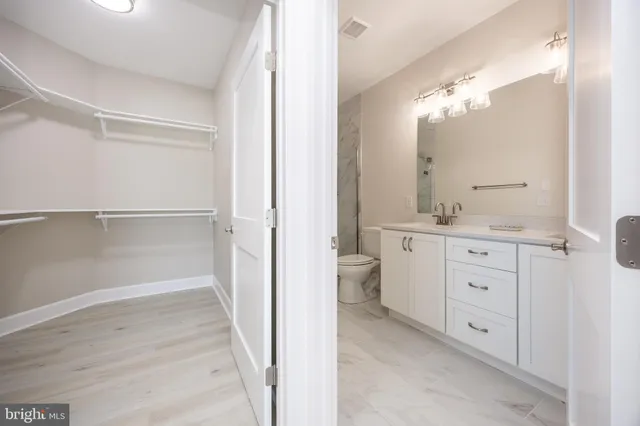 a bathroom with a double vanity sink and mirror with shower