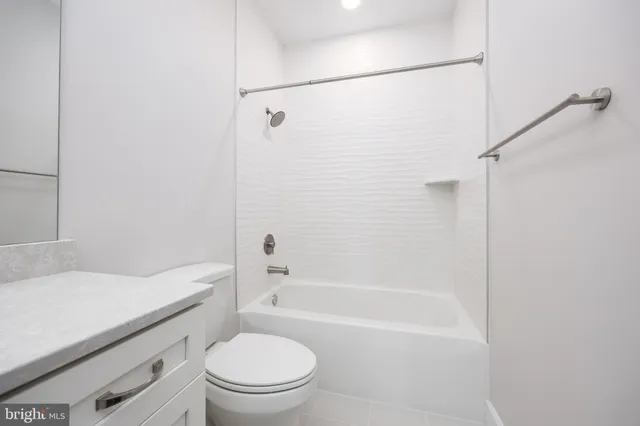 a bathroom with a sink toilet vanity and shower