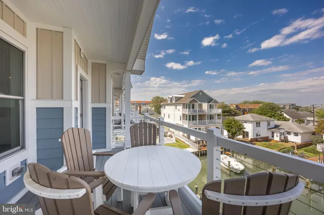 a balcony with table and chairs