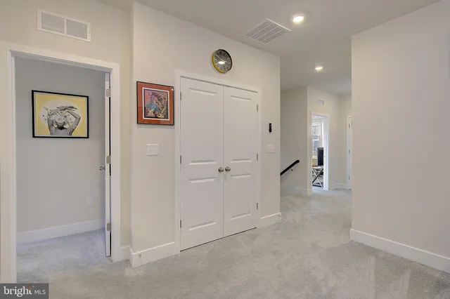 an empty room with closet and a bathroom