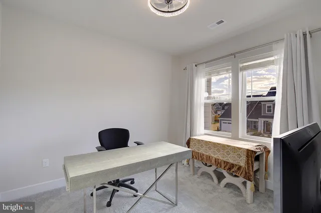 a view of a workspace with furniture