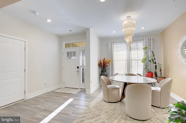 a dining room with furniture and a chandelier