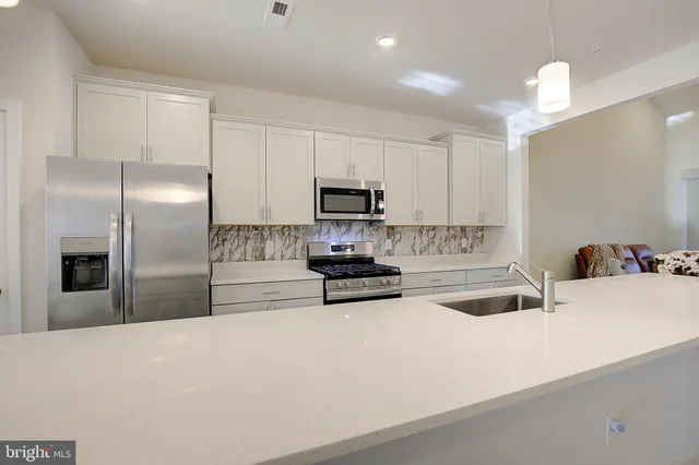 a kitchen with a refrigerator and a sink