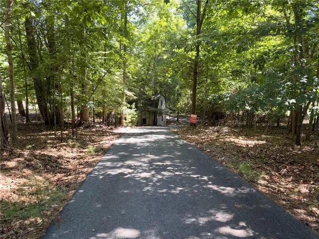 a view of a barn in the middle of a yard