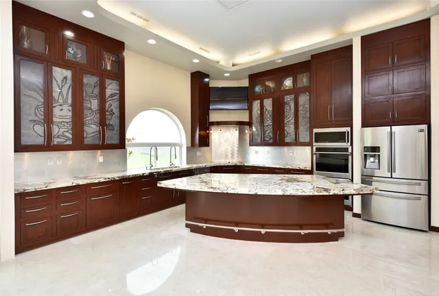 a kitchen with granite countertop a sink and cabinets