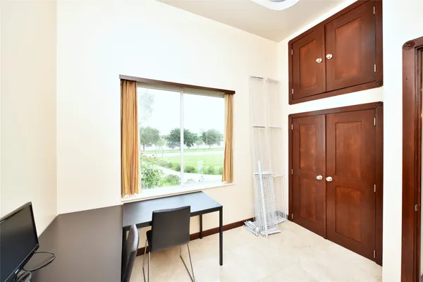 a bedroom with a bed and large window