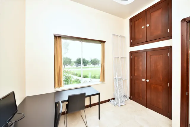 a bedroom with a bed and large window