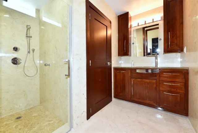 a bathroom with a granite countertop sink toilet and shower