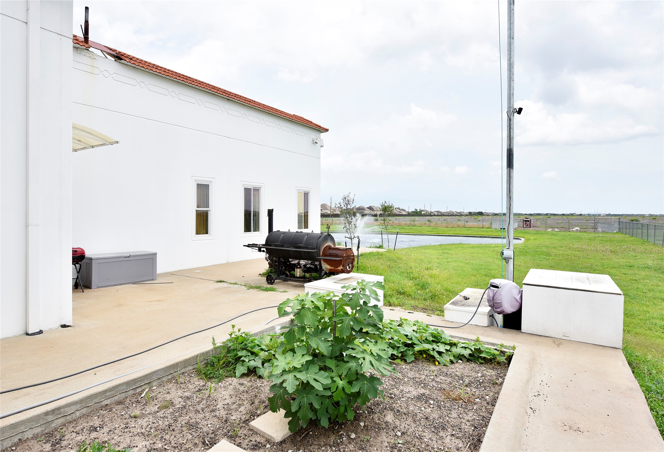 6602 Rohan Road Richmond, TX 77469 - Photo 36 of 49 a view of a patio with chairs and table potted plants