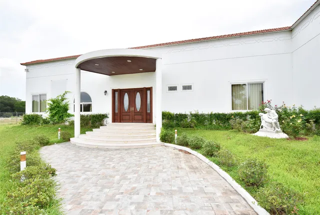 a front view of a house with garden