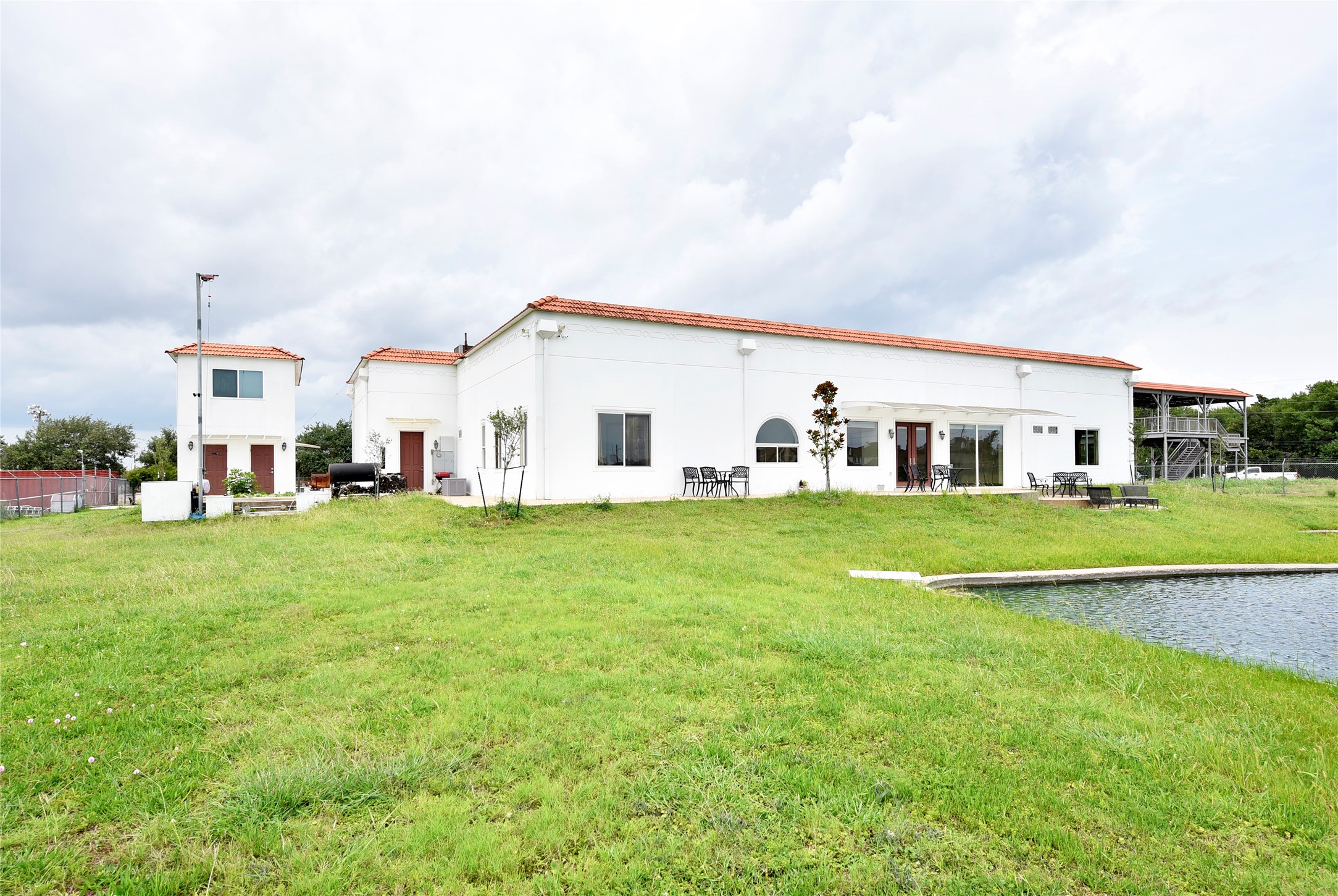 6602 Rohan Road Richmond, TX 77469 - Photo 43 of 49 a view of a white house with a big yard and large trees