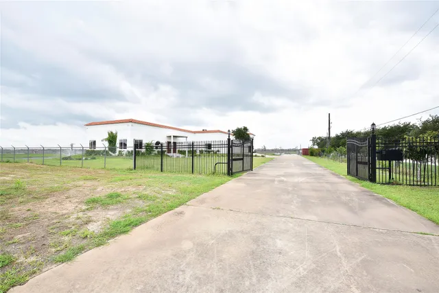 a view of a big room with windows and chandelier