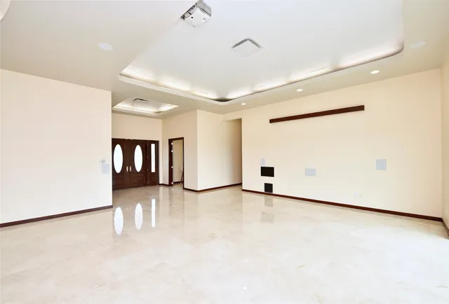 a view of a livingroom with furniture and floor to ceiling window