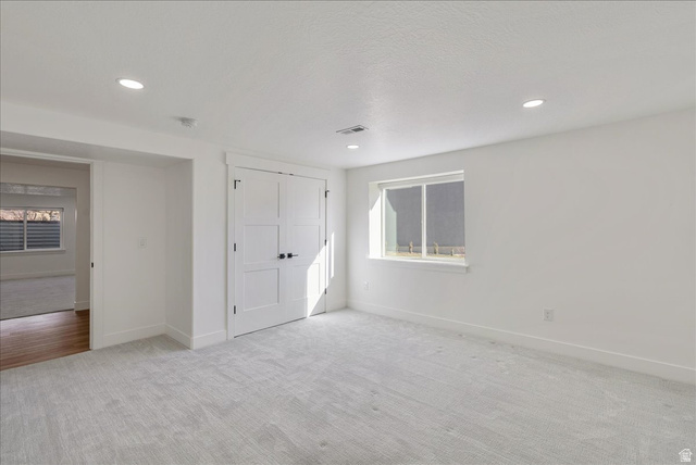 882 Spring Dew Lane Lehi, UT 84048 - Photo 46 of 46 Unfurnished bedroom featuring light carpet, a closet, and recessed lighting