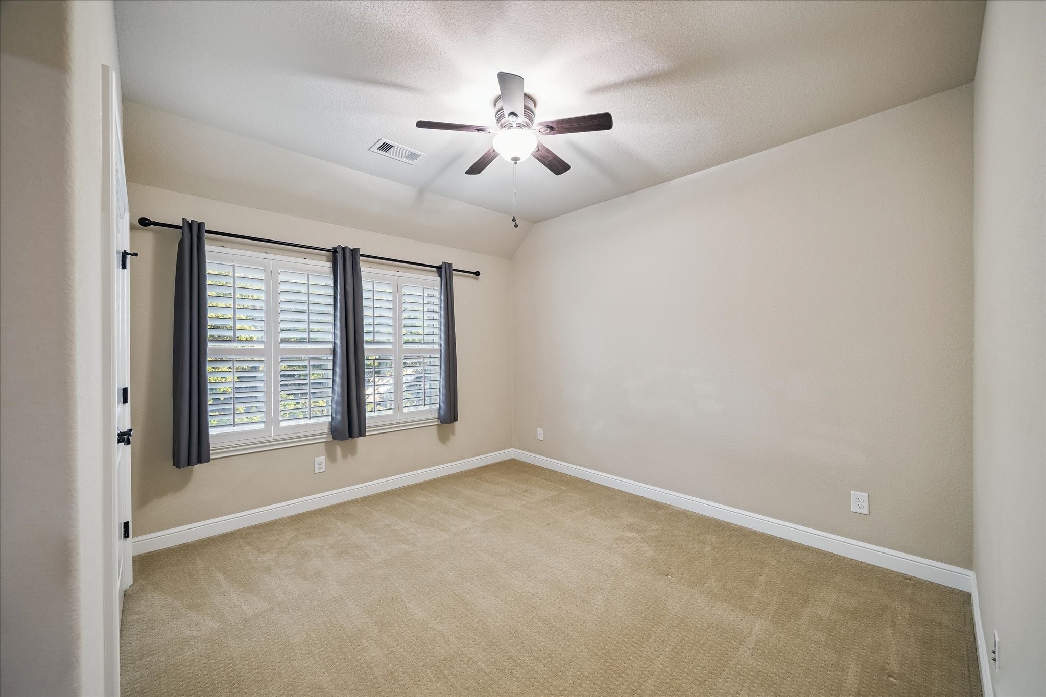 35 North Fremont Ridge Loop Spring, TX 77389 - Photo 27 of 37 This inviting secondary bedroom features plantation shutters, soft natural light, and a spacious layout. Thoughtfully designed to provide comfort and flexibility for family, guests, or a personalized workspace.