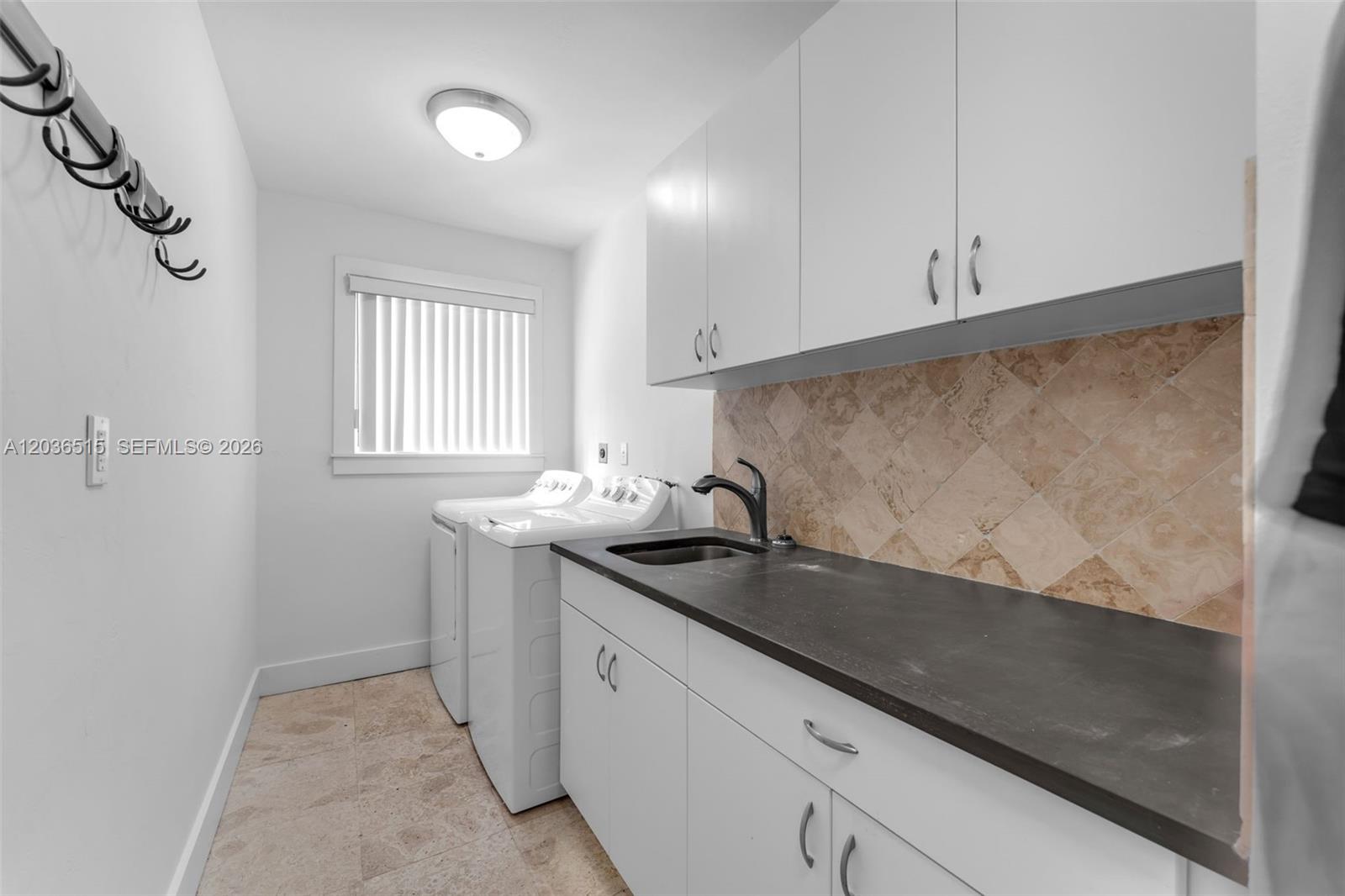 7711 Erwin Road Coral Gables, FL 33143 - Photo 21 of 26 a kitchen with granite countertop a sink and cabinets