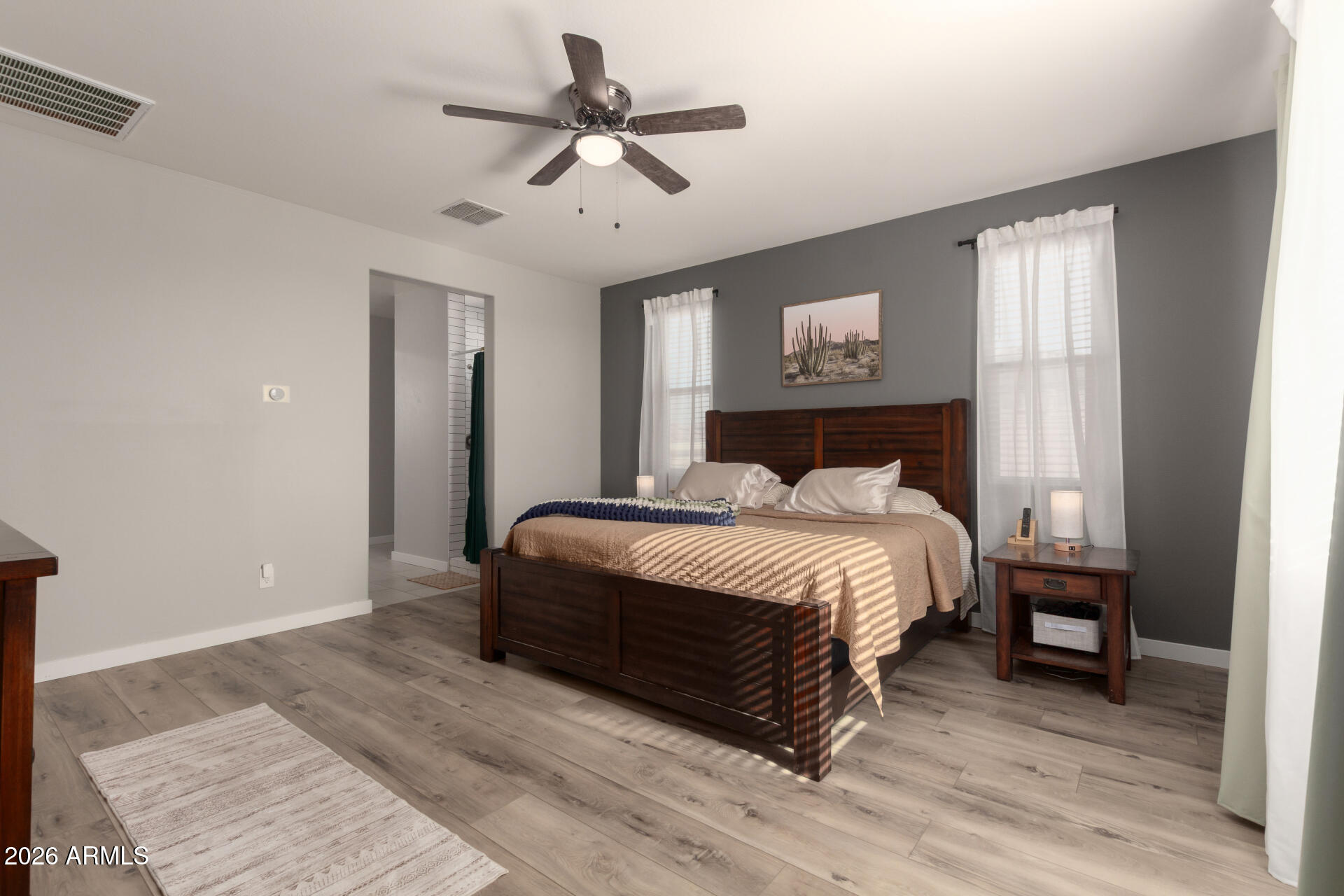 21073 West Berkeley Road Buckeye, AZ 85396 - Photo 14 of 41 a bedroom with a bed and a window