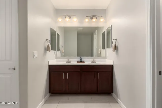 a bathroom with a double vanity sink and a mirror