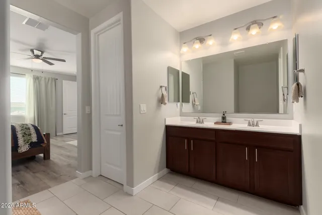 a spacious bathroom with a double vanity sink and a mirror
