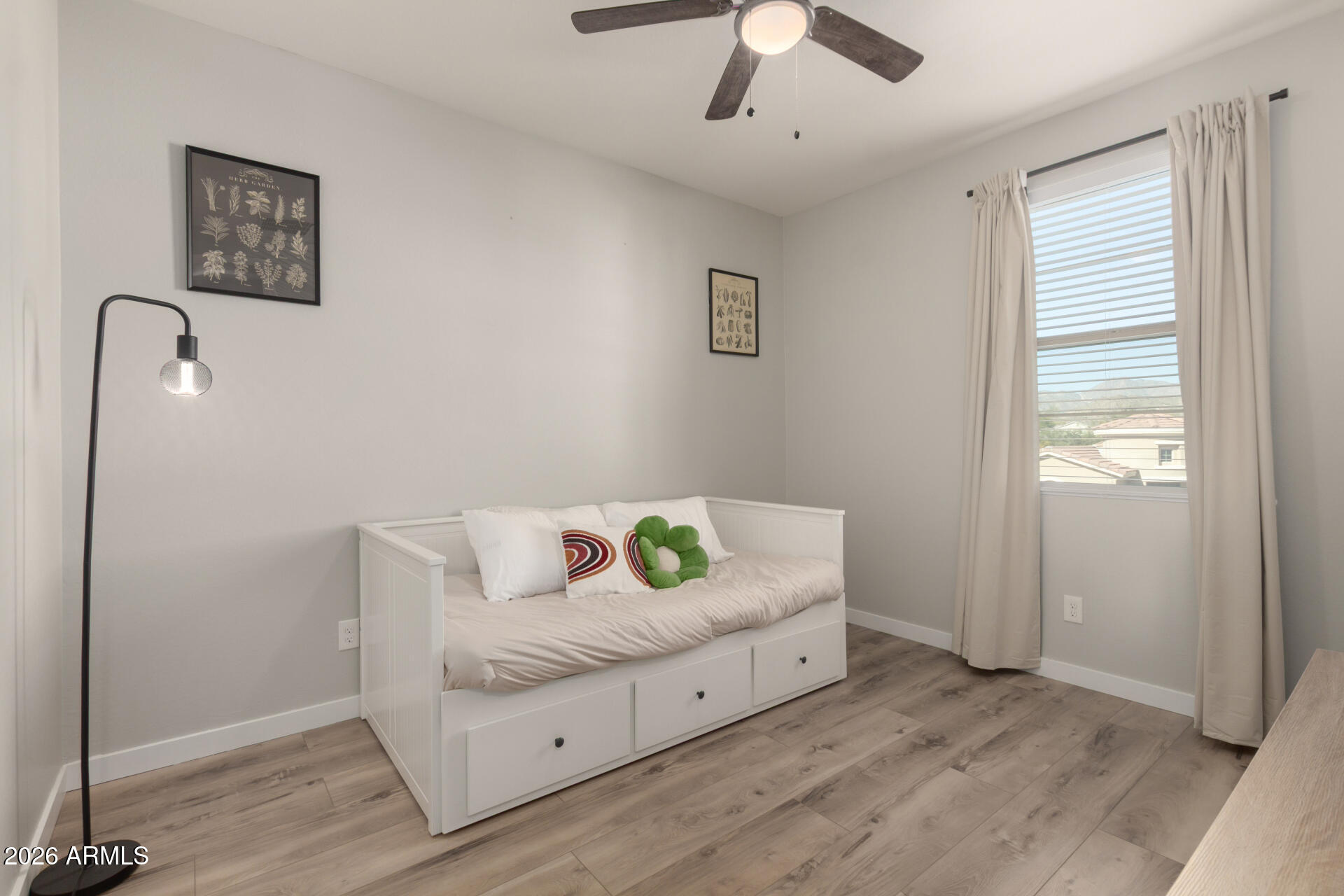 21073 West Berkeley Road Buckeye, AZ 85396 - Photo 23 of 41 a bedroom with a bed and a window