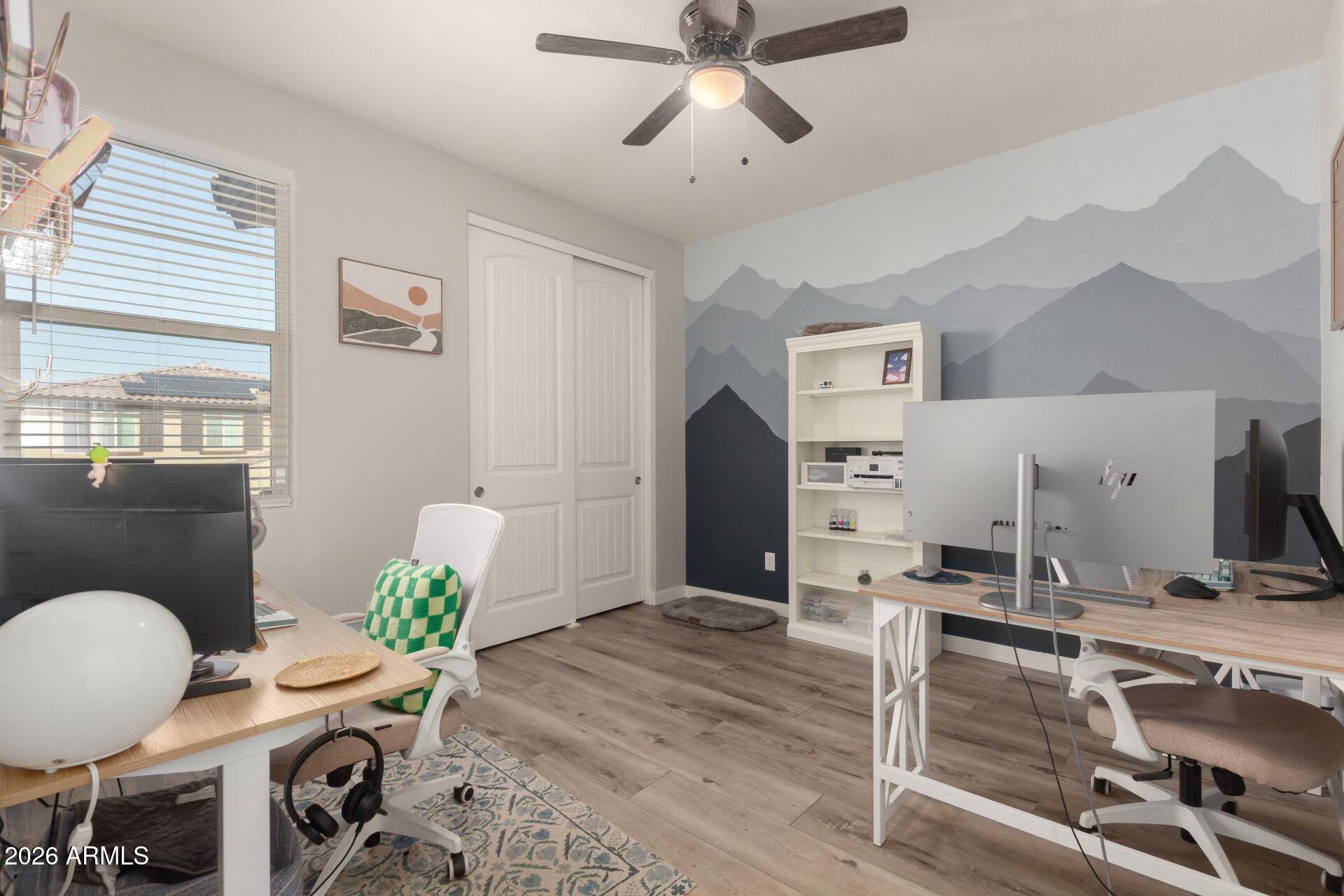 21073 West Berkeley Road Buckeye, AZ 85396 - Photo 24 of 41 a workspace with furniture and wooden floor