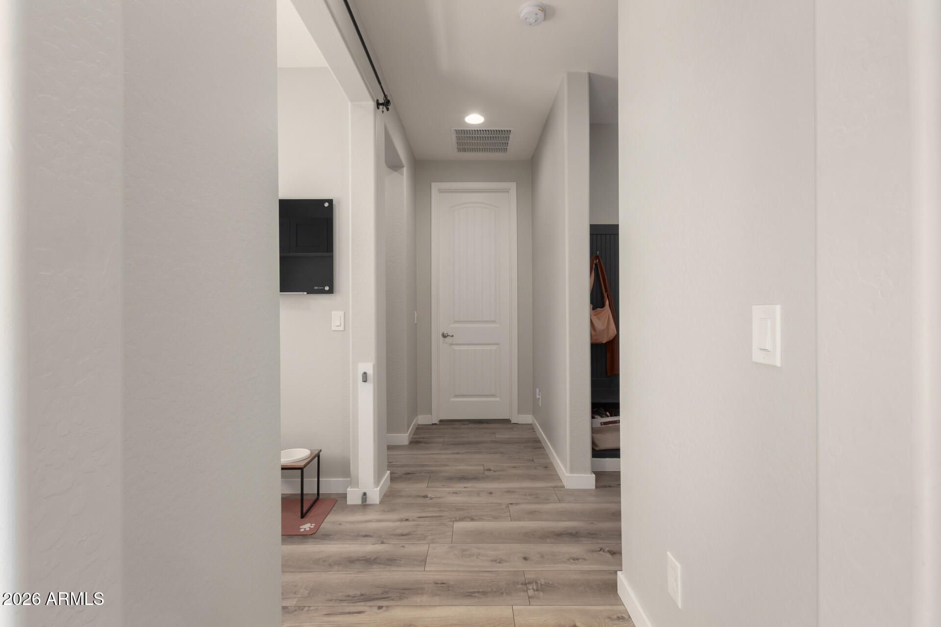 21073 West Berkeley Road Buckeye, AZ 85396 - Photo 3 of 41 a view of a hallway with wooden floor and a bathroom