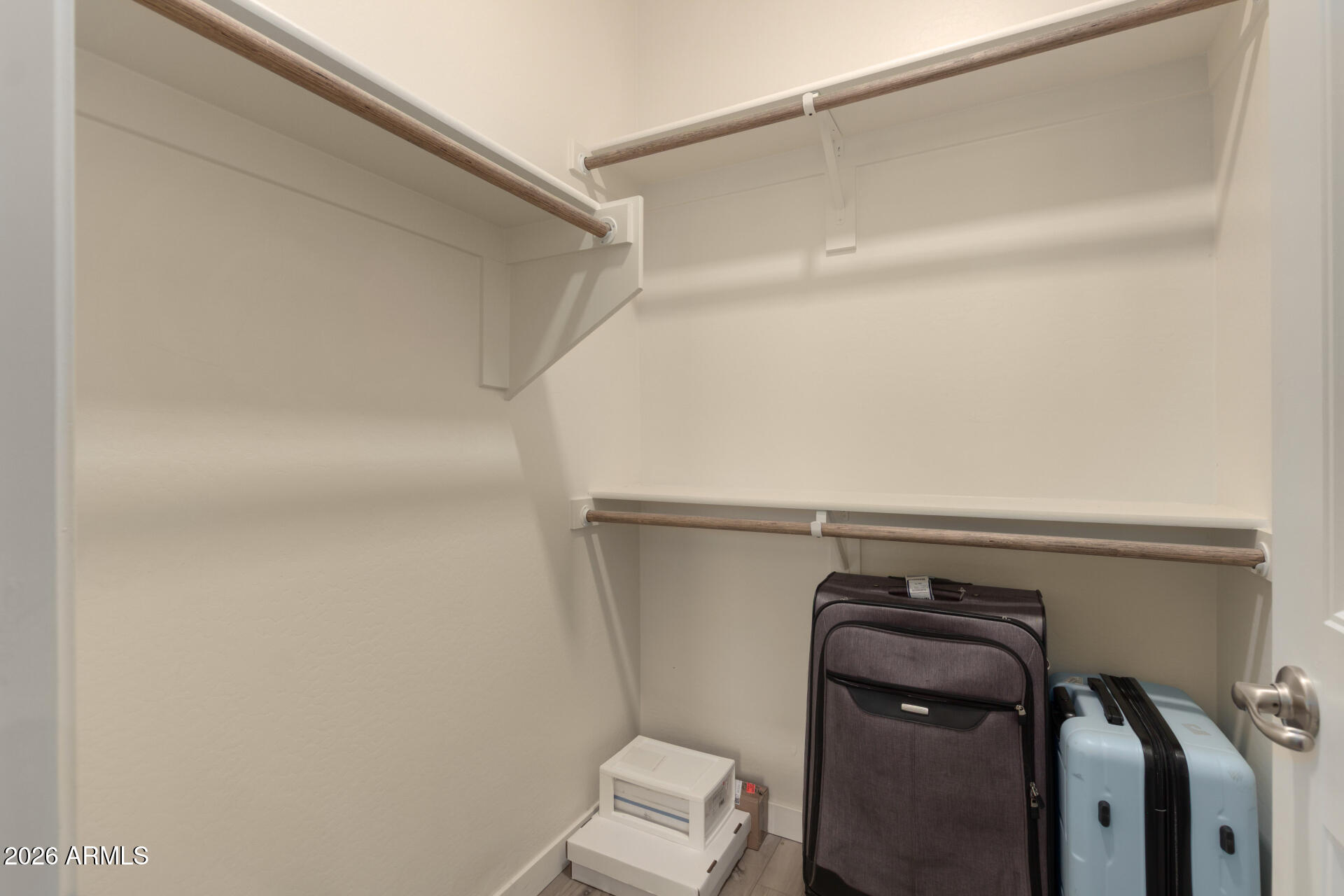 21073 West Berkeley Road Buckeye, AZ 85396 - Photo 34 of 41 a view of walk in closet with clothes and shoes