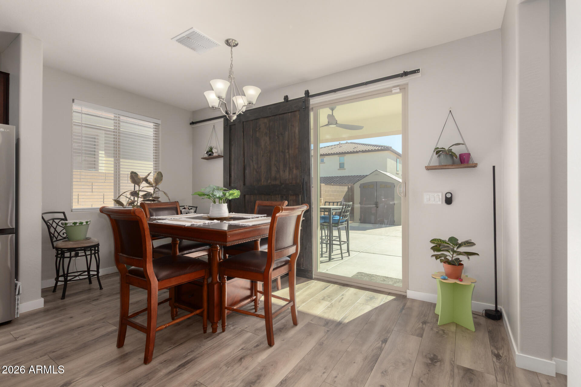 21073 West Berkeley Road Buckeye, AZ 85396 - Photo 8 of 41 a view of a dining room with furniture window and wooden floor