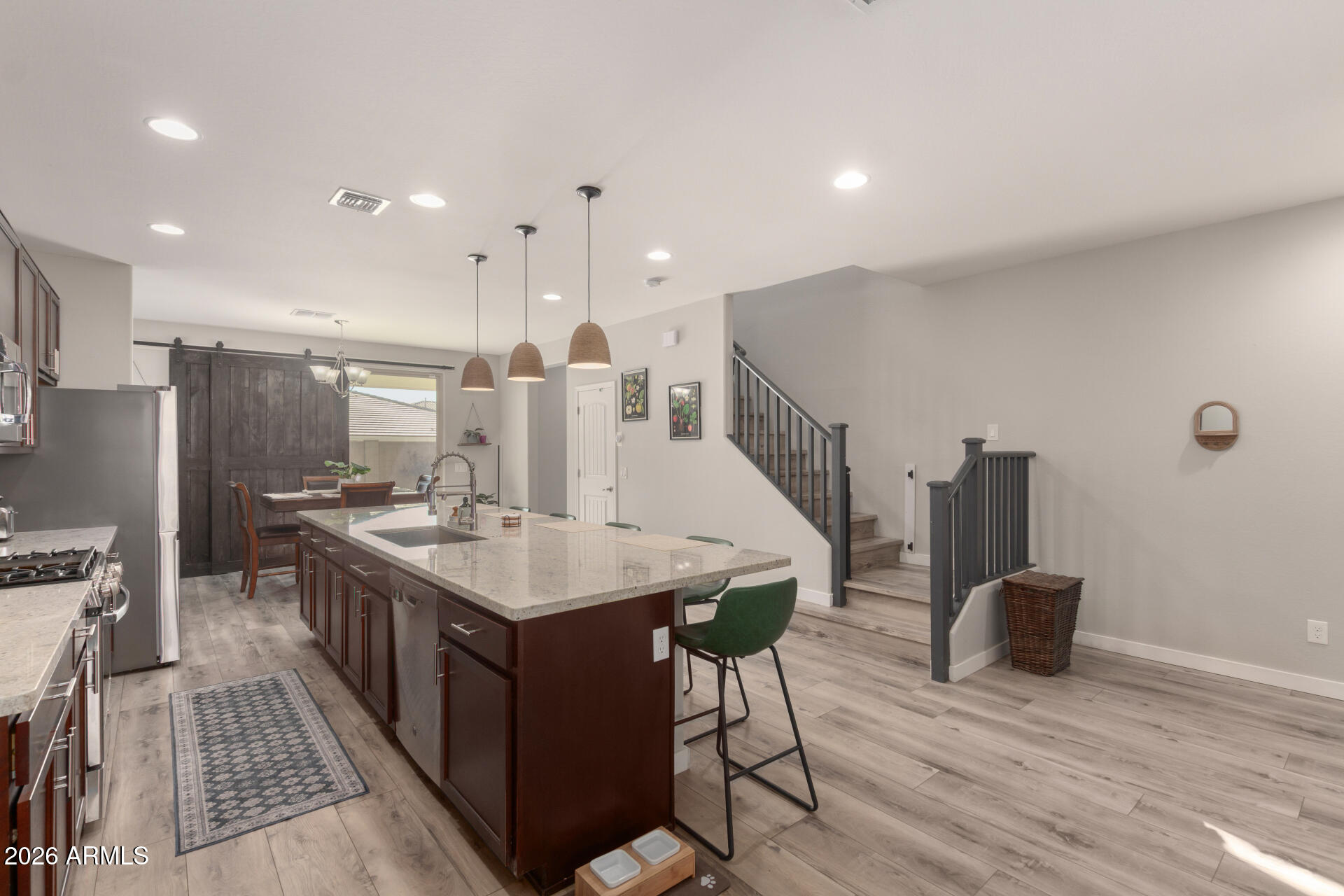 21073 West Berkeley Road Buckeye, AZ 85396 - Photo 10 of 41 a kitchen with a table and chairs