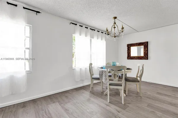 a view of a dining room with furniture window and wooden floor