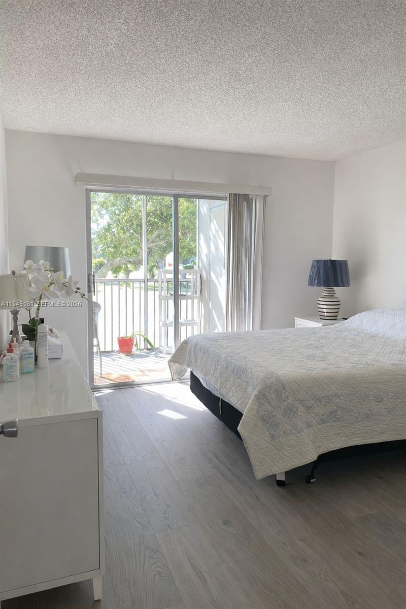 400 Southwest 134th Way, Unit 201F Pembroke Pines, FL 33027 - Photo 18 of 28 a bedroom with a bed and a large window