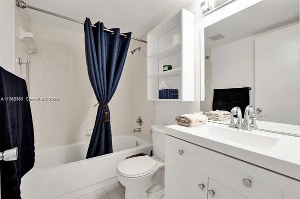 a bathroom with a sink a toilet a tub and shower