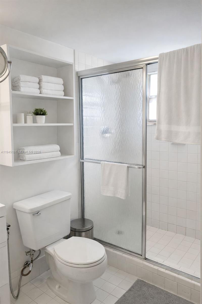 400 Southwest 134th Way, Unit 201F Pembroke Pines, FL 33027 - Photo 20 of 28 a bathroom with a toilet and a shower