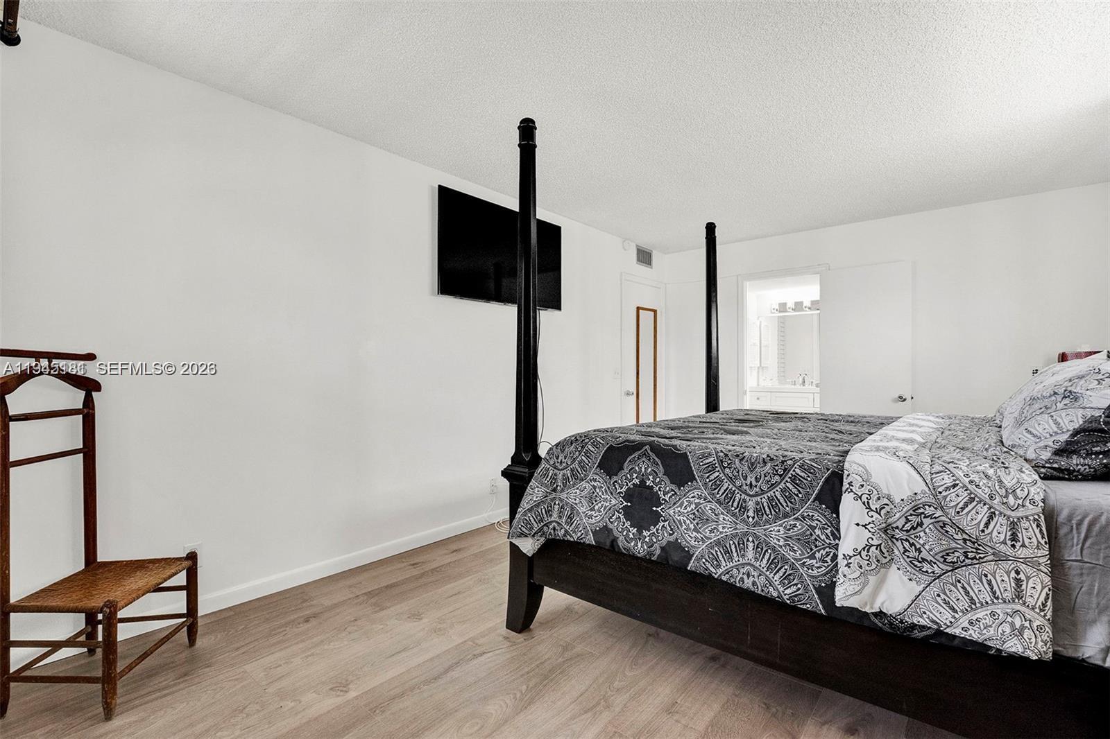 400 Southwest 134th Way, Unit 201F Pembroke Pines, FL 33027 - Photo 22 of 28 a bedroom with a bed and a flat screen tv