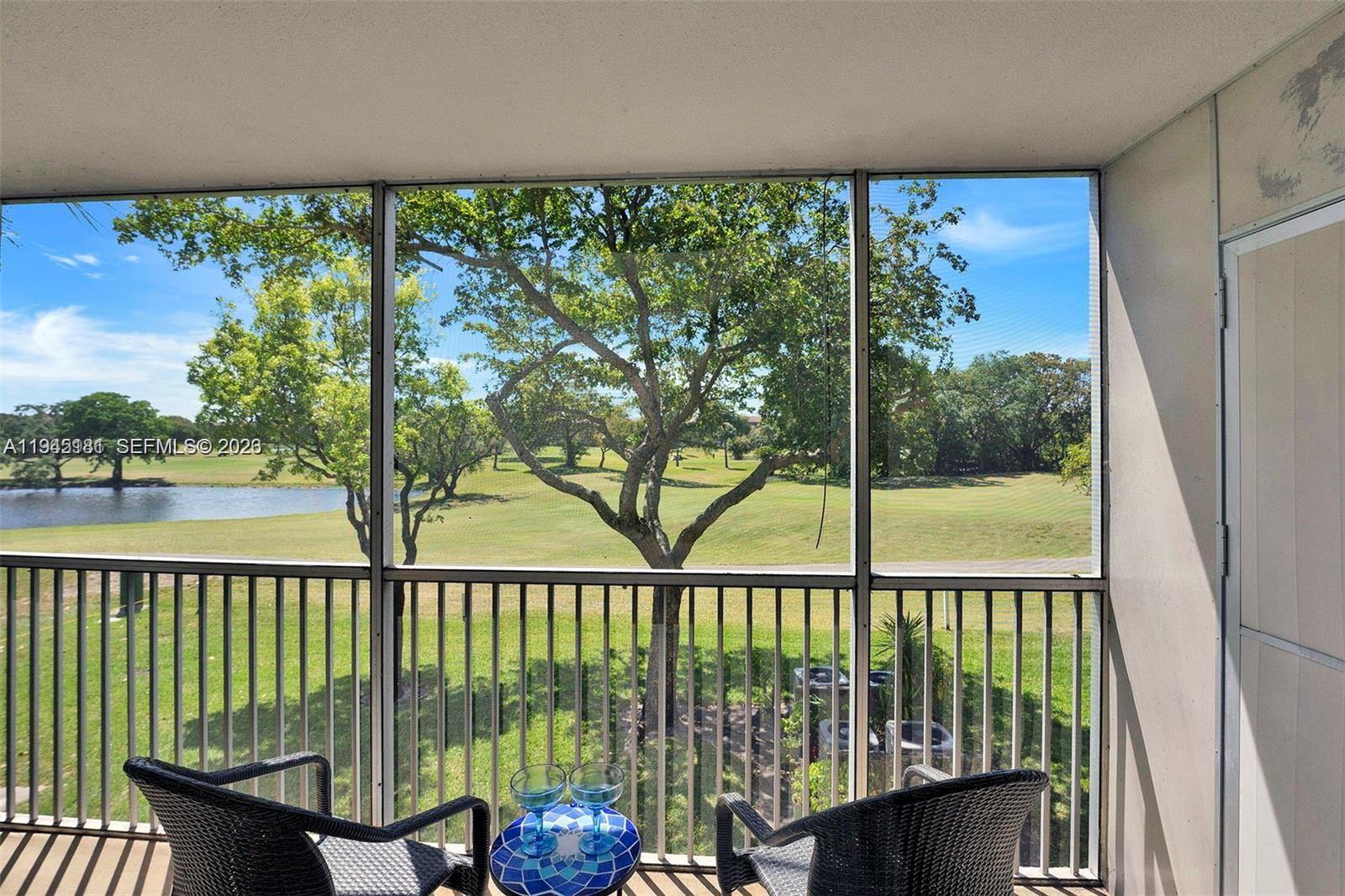 400 Southwest 134th Way, Unit 201F Pembroke Pines, FL 33027 - Photo 27 of 28 a view of a balcony with furniture and a floor to ceiling window