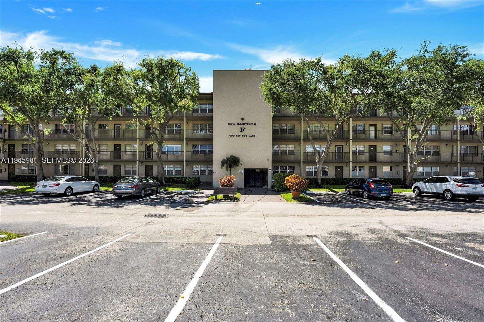 400 Southwest 134th Way, Unit 201F Pembroke Pines, FL 33027 - Photo 6 of 28 a view of car parked on the side of a street