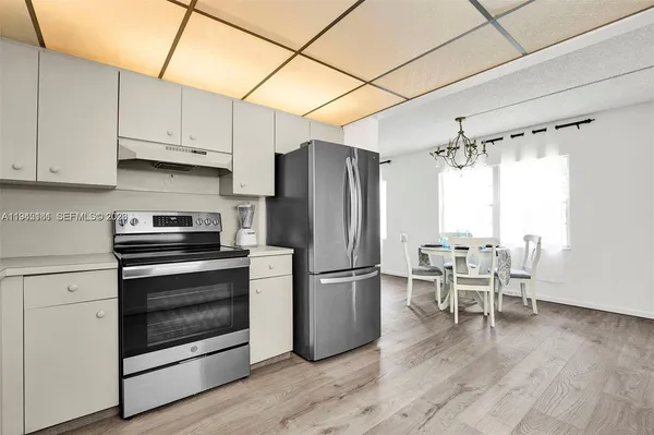 a kitchen with wooden floors and stainless steel appliances