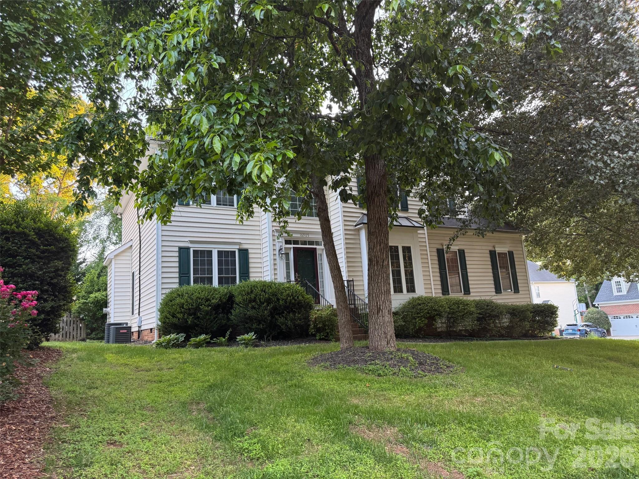 16905 Laureate Road, Unit 16 Huntersville, NC 28078 - Photo 2 of 38 a front view of a house with a garden