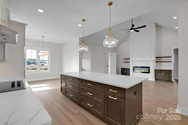 a spacious bathroom with a granite countertop sink a mirror and shower