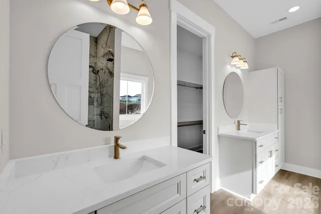 a bathroom with a sink vanity and mirror