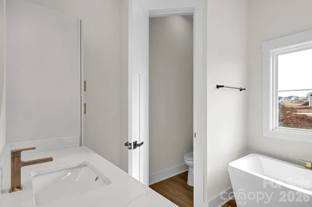 a bathroom with a tub toilet and sink