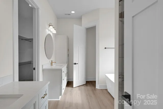 a bathroom with a sink a mirror and a bathtub