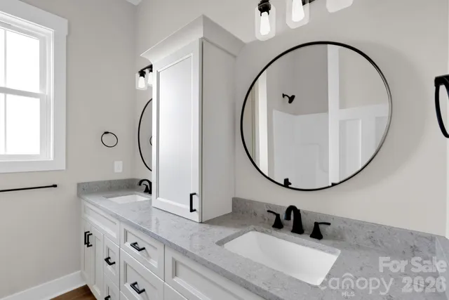 a bathroom with a sink double vanity and a mirror