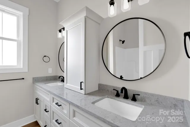 a bathroom with a sink double vanity and a mirror