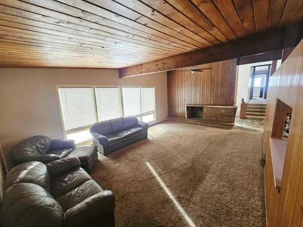 a room with furniture and a ceiling fan