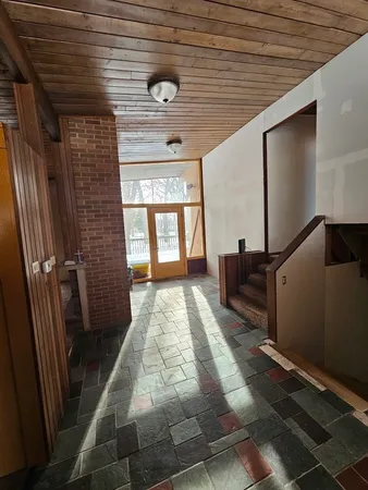 a view of an empty room with a fireplace
