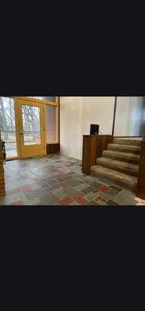 a living room with stainless steel appliances kitchen island granite countertop furniture and a shower