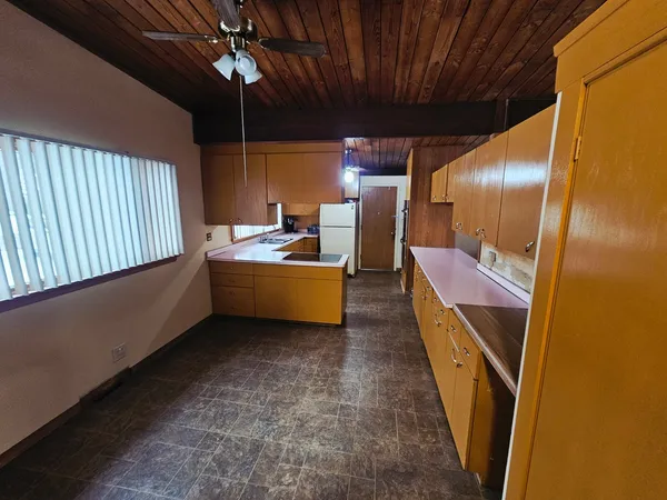 a kitchen with refrigerator and window
